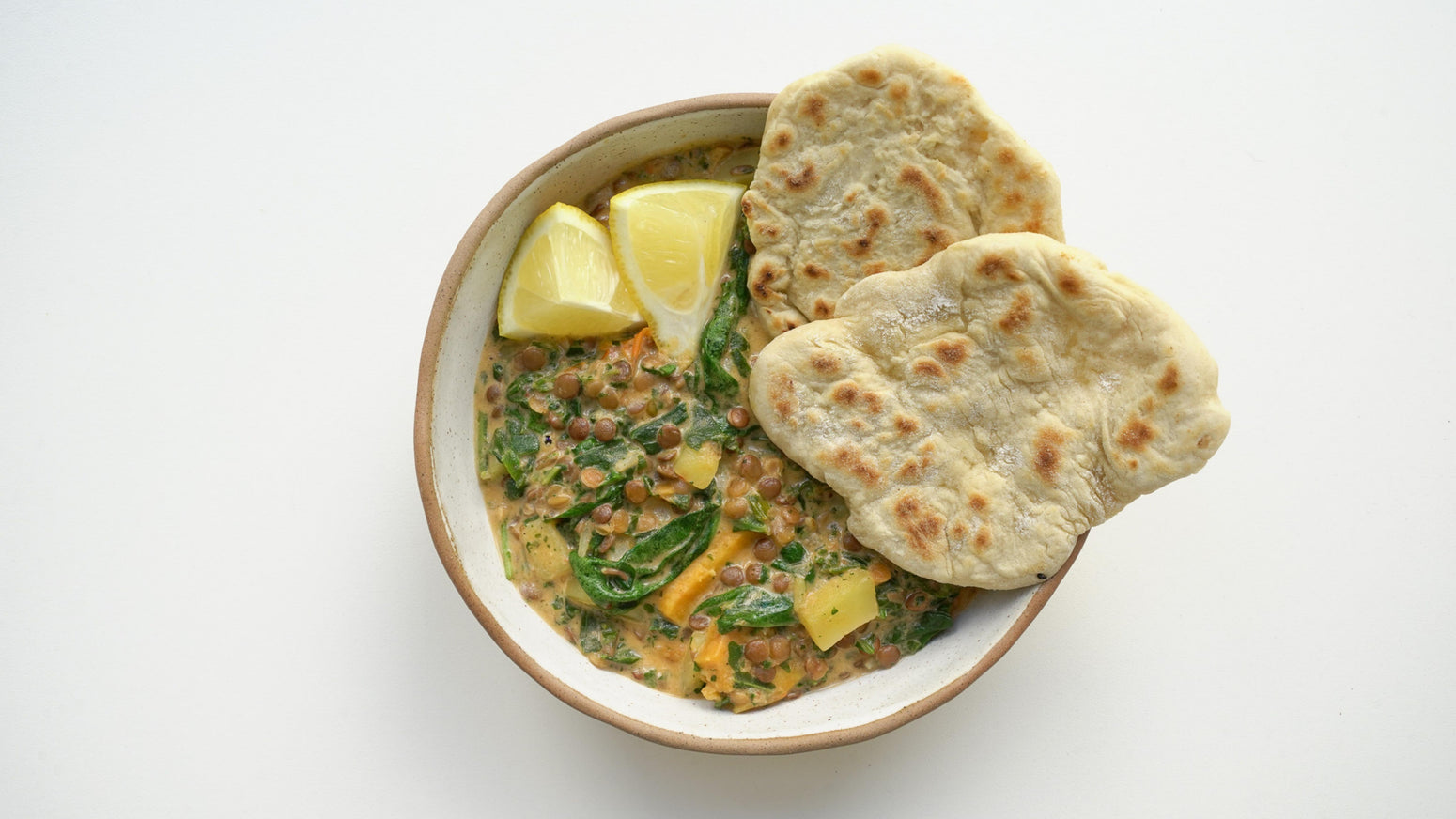 Green Dal mit Naan Brot und Zitrone